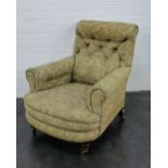 Victorian upholstered button back armchair, with turned mahogany supports with brass caps and