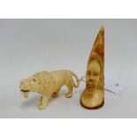 withdrawn Two early 20th century African carved ivory figures to include a lion and head, (2) tal