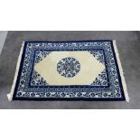 Chinese wool rug, the ivory field with blue border and Chinese key pattern, 76 x 205cm
