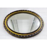 19th century ebonised and parcel gilt oval wall mirror, 60 x 75cm