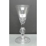 Early 19th century knop stemmed wine glass of unusually large proportions on a circular foot rim,