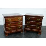 Pair of contemporary American cherrywood bedside cabinets with three short drawers, raised on