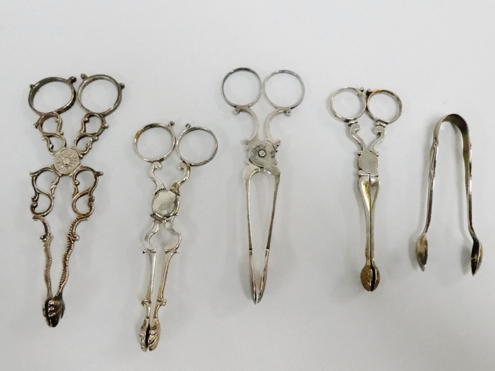 A collection of sugar tongs / nips to include a pair of Victorian silver tongs and four others (5)