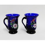 Pair of bell shaped Bristol blue glass mugs, painted in coloured enamels with flowers and worn
