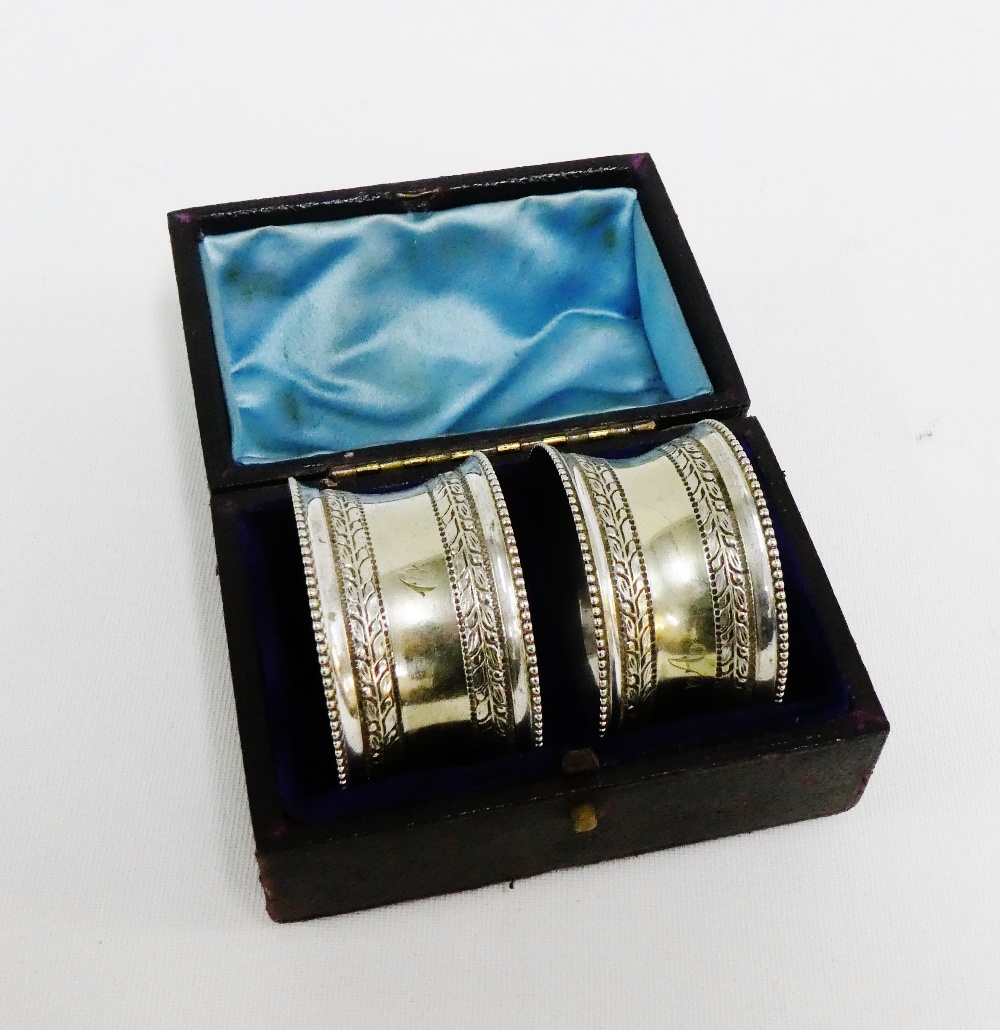A pair of Epns engraved napkin rings contained within original leather box