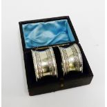 A pair of Epns engraved napkin rings contained within original leather box