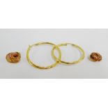 A pair of 9 carat gold hoop earrings together with a pair of yellow metal knotwork earrings (2)