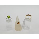 Three 9 carat gold gemset dress rings to include a white gold peridot ring, UK ring sizes N & O (3)