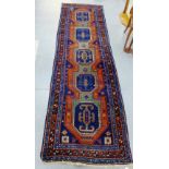 An Eastern runner with blue field and geometric motifs, 310 x 92cm