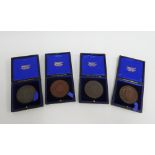 Four early 20th century bronze medallions, leather cased (4)