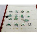 A quantity of silver and white metal emerald set jewellery to include dress rings, pendants and