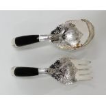 Silver and ebony salad servers with pierced and foliate engraving, bearing Arabic hallmarks or