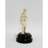 Late 19th / early 20th century carved ivory figure of a gentleman taking snuff, on a circular wooden