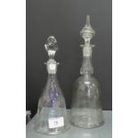 Two bell shaped glass decanters with stoppers, both with etched patterns to include palm trees and