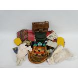 Carton containing a collection of ladies vintage evening bags, an embroidered panel, a travelling