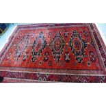 Large Persian carpet, the red field with four medallions and multiple geometric borders, 370 x