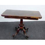 19th century rosewood foldover table on a carved baluster column and quadruped supports with brass