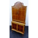 Walnut corner cabinet with arched top and pair of cupboard doors over two short drawers and two