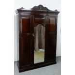 Mahogany wardrobe with carved pediment top over a dentil frieze and central mirror door, 238 x