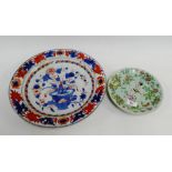 Chinese Imari shallow charger together with a Celadon glazed plate, both with restoration, largest