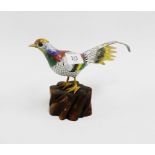 Cloisonne bird perched upon a wooden base, 15cm high