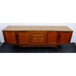 Retro teak sideboard, the rectangular top over four central drawers, flanked by a pair of cupboard