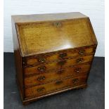 19th century oak bureau, the fall front opening to reveal a fitted interior, above four graduating