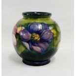 Moorcroft vase of squat globular form, the green and blue ground tube line decorated with flowers,