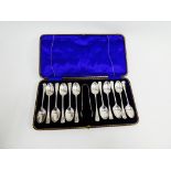 Edwardian silver set of twelve teaspoons and matching sugar tongs, with bright cut floral