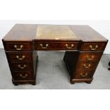 Georgian style mahogany and ebony desk with a central frieze drawer flanked by four short drawers,