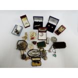 A carton containing a quantity of vintage and later costume jewellery to include dress rings,