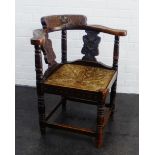 Carved oak corner chair with floral motifs and woven seat, 82 x 73cm