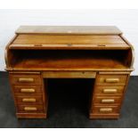 Early 20th century oak roll top desk, the tambour front opening to reveal a fitted interior over