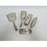 Silver backed dressing table brush set comprising mirror, hairbrush, two clothes brushes and a small