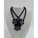 Butler & Wilson black bead necklace and matching bracelet with triple flower heads, with pink