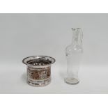 Silver plate on copper bottle stand with turned wooden base together with a glass carafe, (2)