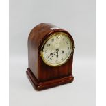 Mahogany cased mantle clock, the arched top over a silvered dial with Arabic numerals inscribed "