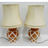 Pair of terracotta and white glazed table lamps and shades, (2)