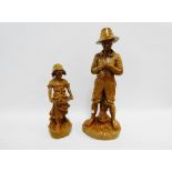 Two brown painted plaster figures of a boy and a girl with a basket of puppies, tallest 56cm, (2)