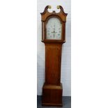 Oak cased grandfather clock with broken swan neck over a 12 inch dial with Roman numerals and