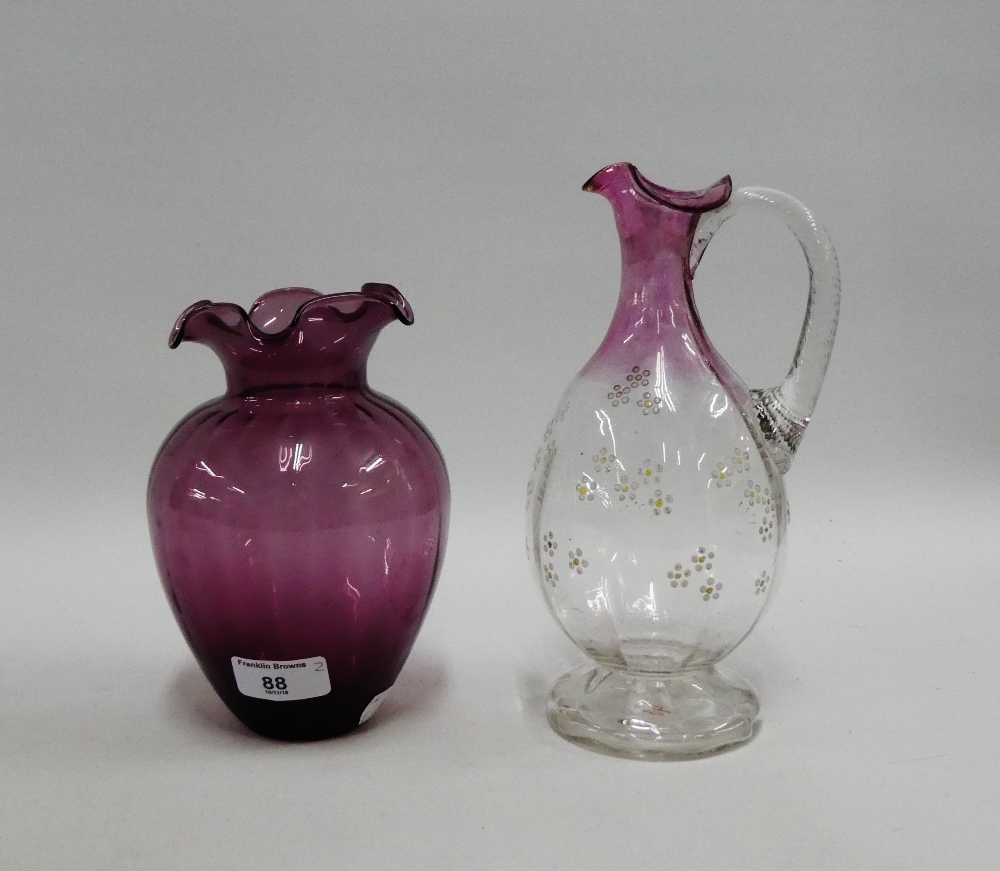 Victorian glass water jug with enamelled flowers, together with an aubergine glass vase with frilled