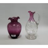 Victorian glass water jug with enamelled flowers, together with an aubergine glass vase with frilled