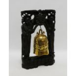 Chinese brass gong on a carved ebonised wooden figural base, overall height 43cm