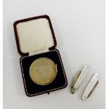 Birmingham silver Dux medal together with two silver and mother of pearl fruit knives (3)