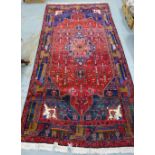 Persian rug with red field, with central flowerhead medallion within flowerhead borders, 315 x