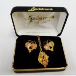 9 carat rose and yellow gold vine leaf and grape pendant on a 9 carat gold chain together with a