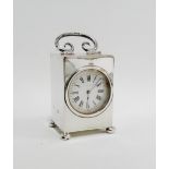 Edwardian miniature silver cased clock with a swing handle to top and four bun feet, by