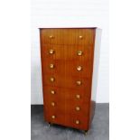 Retro veneered chest with seven long drawers and ebonised supports with brass caps, 125 x 61cm