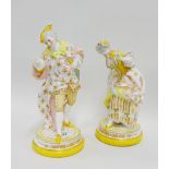 Pair of continental porcelain yellow and white glazed male and female figures, each modelled