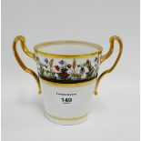 Continental porcelain twin handled beaker vase with gilt rims and hand painted floral border, 13cm